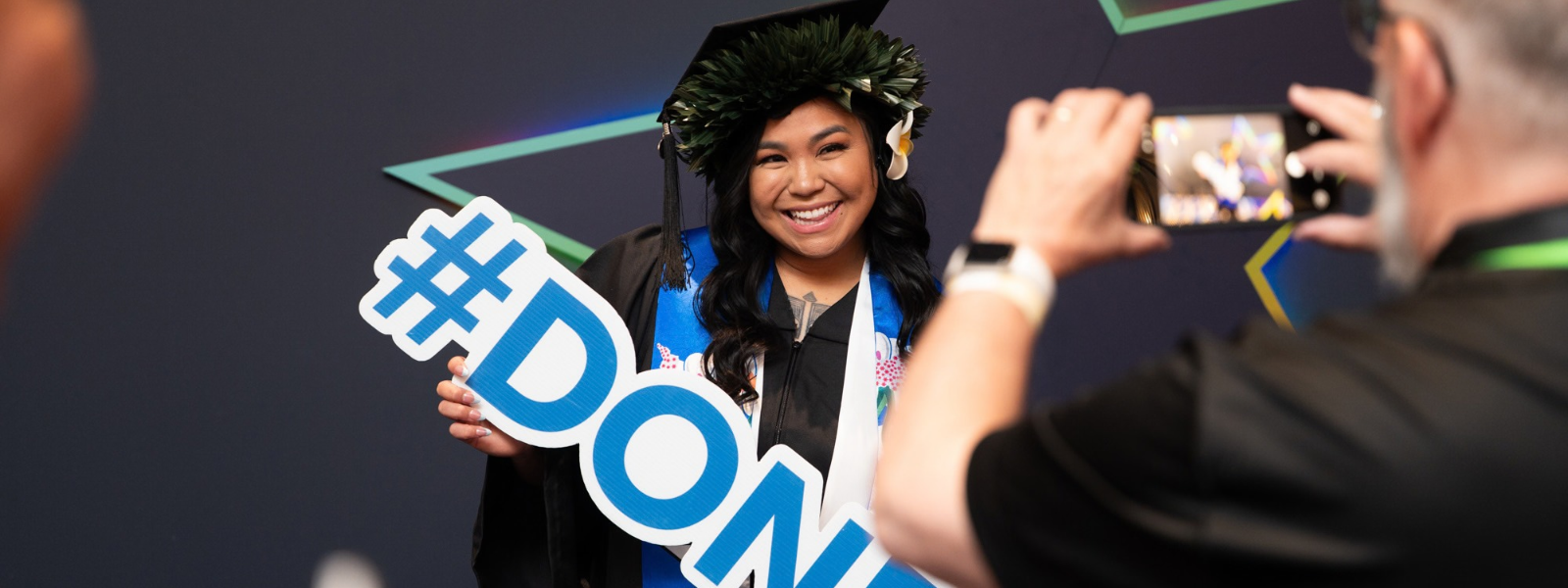 Graduate holding #done sign