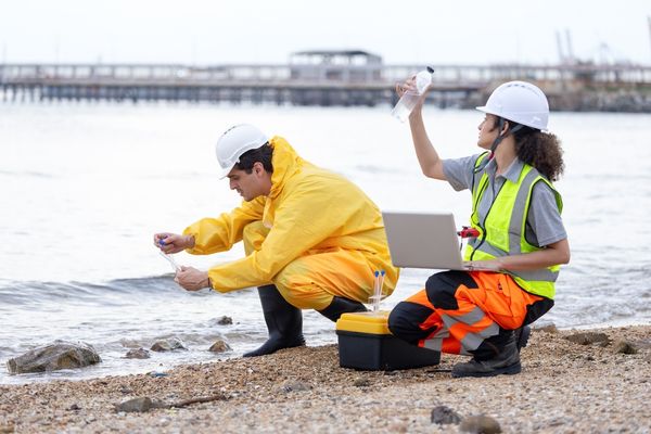 environmental scientists examining water