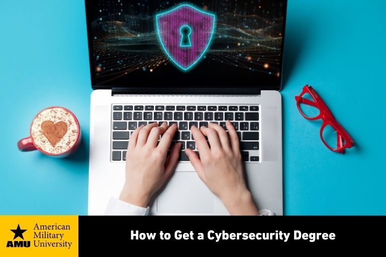 cybersecurity degree graduate typing on laptop
