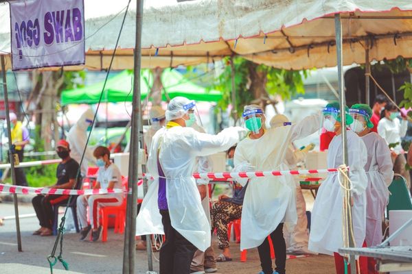 public health employees working at outdoor clinic