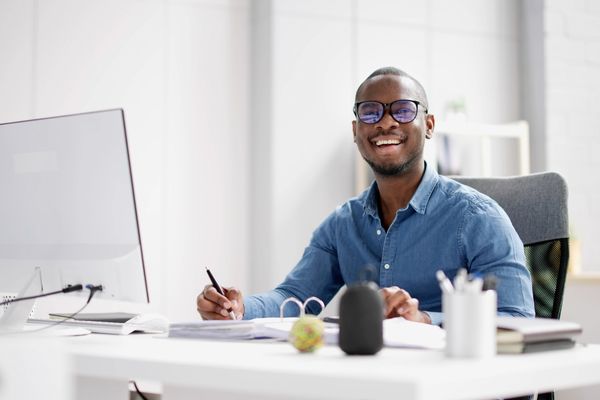 business degree student smiling at desk