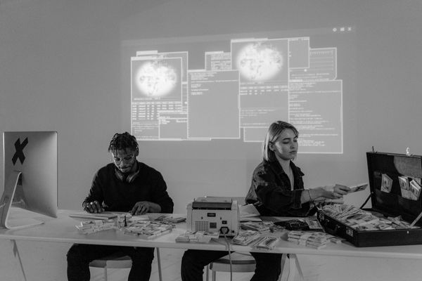 cybersecurity professionals working on laptops