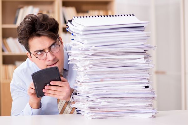 accounting professional holding calculator by documents