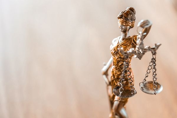 criminal justice symbolic statue of blindfolded woman holding scale and sword