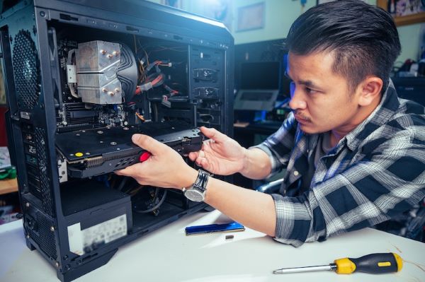 man inspecting basic components of a computer